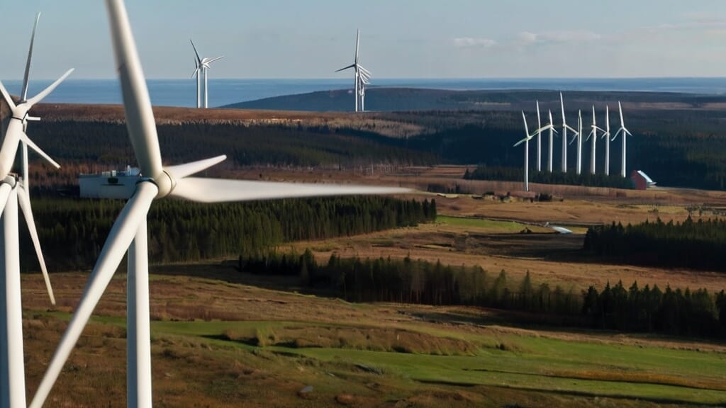 Eine Luftaufnahme von Windkraftanlagen auf einem Feld, die die Kraft nachhaltiger Energie demonstriert.